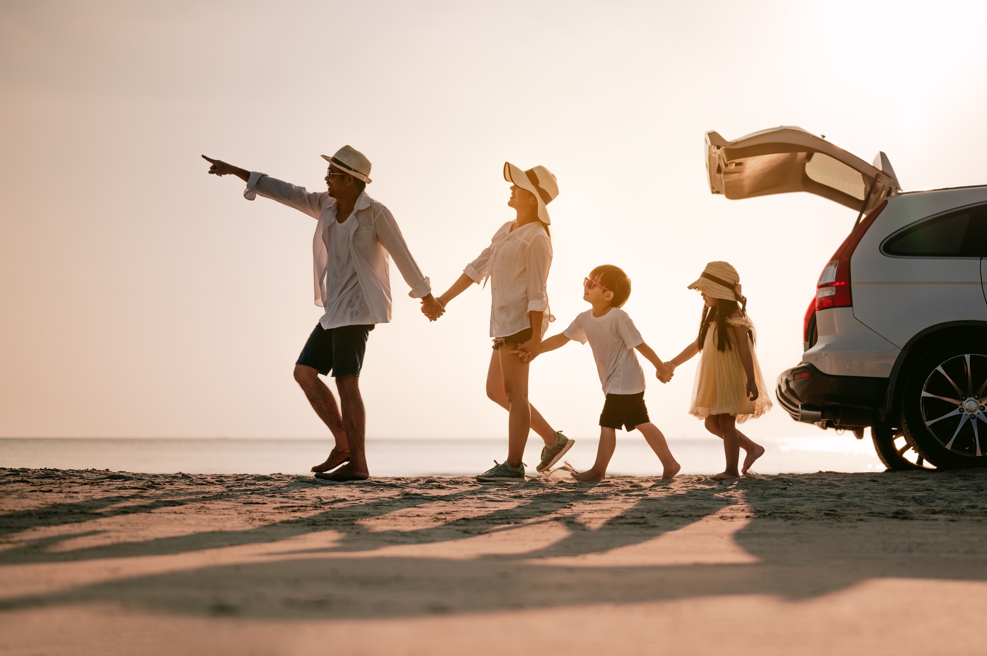 Asian family on the beach.Vacation time. Happy father, mother and son enjoying road trip